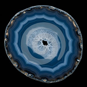 Cross-section of a blue agate geode displaying concentric layers of blue and white.