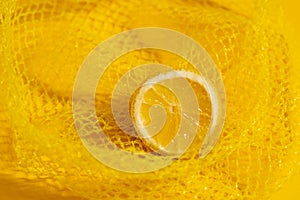 Cross section lemon yellow slice background close-up net netting packing package