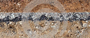 Cross-section of the pavement with layers of clay sand and asphalt