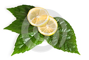 Cross section of yellow lemon with green leaf