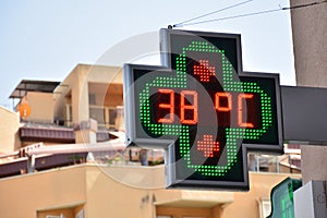 Street thermometer of a pharmacy at 38 degrees celsius photo