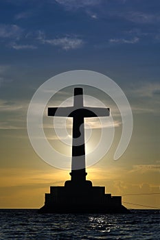 Cross silhouette over sunset