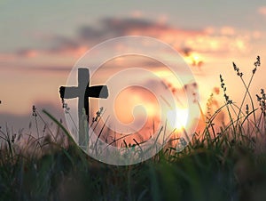 a cross silhouette standing in a field, with the warm glow of a sunset sky