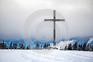 Cross in the snow. Wooden religious cross in winter. Les Pleiades, Switzerland