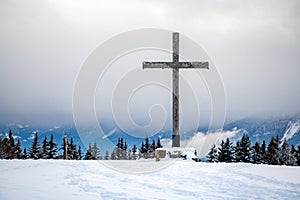 Cross in the snow. Wooden religious cross in winter. Les Pleiades, Switzerland photo