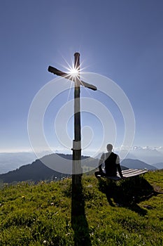 Cross with sun and man