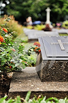 Cross on tombstone in cemetery.