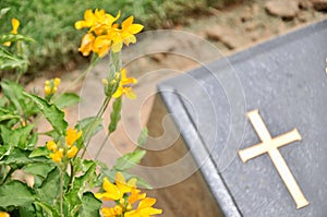 Cross on tombstone in cemetery.