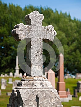 Cross on top of cemetery grave marker