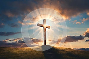 A cross on top of the hill backlit by soft light beams. Cross on top of mountain.