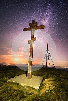 Cross on top of the mountain and stars