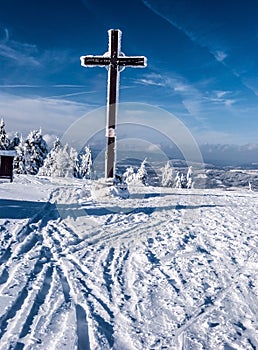 Cross on Velka Raca hill in winter Kysucke Beskydy mountains on slovakian - polish borders