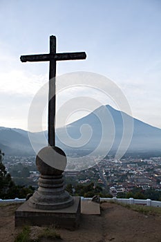 Cross and volcano over Antigua Guatemala valley