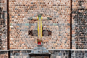 Cross at the wall of Convent of Santo Domingo in Koricancha complex in the city of Cusco, Peru photo