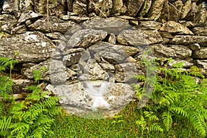 Cross on wall marking where wheel was found after explosion