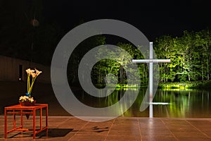 Cross on the water with an inverted reflection