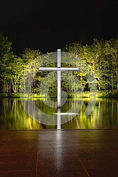 Cross on the water with an inverted reflection