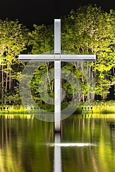 Cross on the water with an inverted reflection