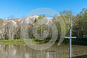 Cross on the water with an inverted reflection