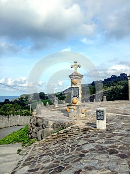 Cross and yellow scallop shell symbol of pilgrimage to Santiago de Compostela in Laredo, Cantabria, Spain