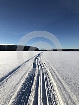 Crosscountry skiing on A Finnish lake photo