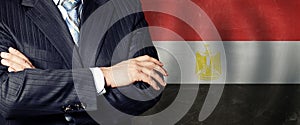 Crossed arms on Egyptian flag background, business, politics and education in Egypt concept