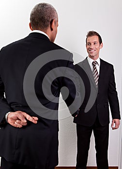 Crossed Fingers At Handshake