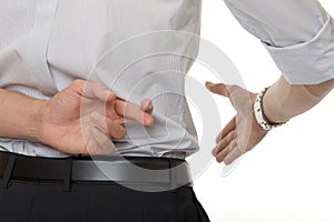 Crossed fingers at handshake