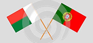 Crossed flags of Madagascar and Portugal