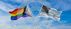 crossed flags of progress lgbt pride and TransAmerica flag waving in the wind at cloudy sky. Freedom and love concept. Pride month