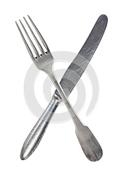Crossed vintage crossed fork and knife isolated on bell background. Rustic style