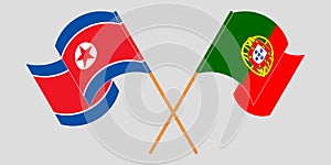 Crossed and waving flags of North Korea and Portugal