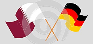 Crossed and waving flags of Qatar and Germany