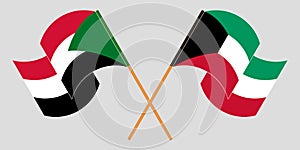 Crossed and waving flags of Sudan and Kuwait photo
