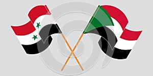 Crossed and waving flags of Syria and Sudan