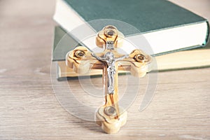 Crosses and book on a wooden table