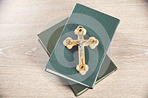 Crosses and book on a wooden table