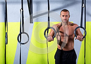 Crossfit dip ring man relaxed after workout at gym