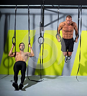 Crossfit dip ring two men workout at gym dipping