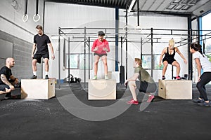 Crossfit group trains box jump