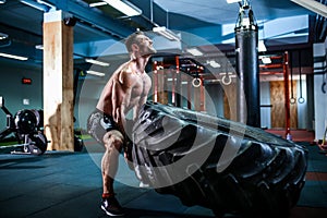 Crossfit training - man flipping tire photo