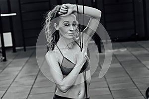 Crossfit woman standing with her front in the gym.