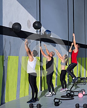 Crossfit workout people group with wall balls and rope