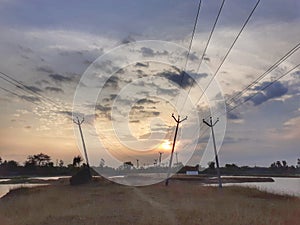 Crossing electric posts , lines with. Sunset.