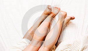 Crossing feet of couple in bed. Sex concept. Healthy and passionate relationship.