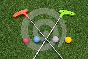 Crossing Mini Golf Putters with Four Balls
