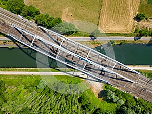 Crossing Paths: Aerial View of a Railway Bridge Over a Canal