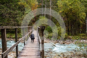 Crossing a wooden footbridge in the forest, somewhere in the Bistrice valley in the Triglav National Park