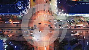 Crossroad from above, city streets, cars and buses, evening traffic