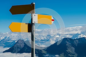 Crossroad signpost in blank concept available, confusion or decisions, in swiss alps